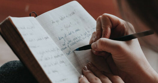 A person writing in a journal