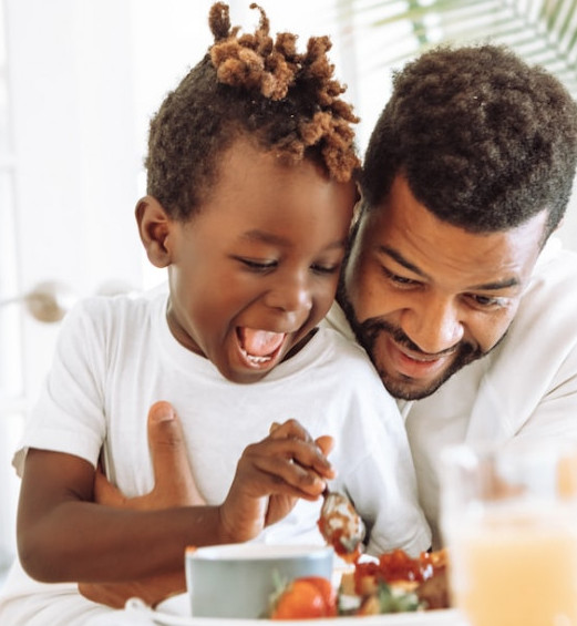 Father and child preparing a meal.